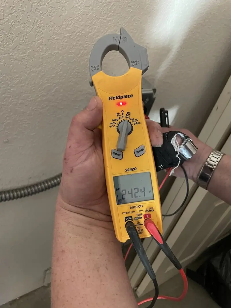 Voltage testing with clamp meter during Recessed Lighting Installation in Fulton
